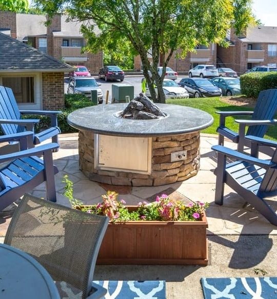 a patio with chairs and a fire pit at The Hickory Highlands