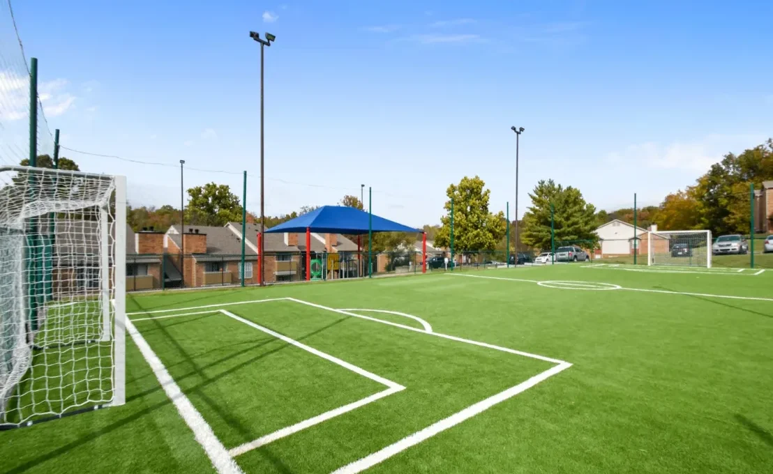 a soccer field with artificial grass and a goal at The Hickory Highlands