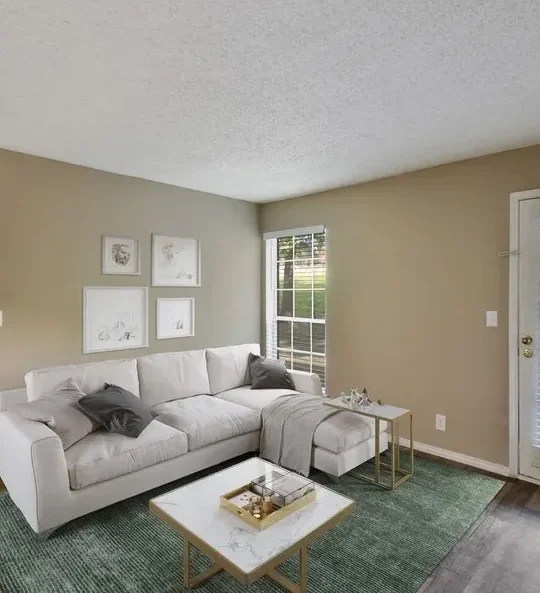 a living room with a couch, coffee table and television at The Hickory Highlands