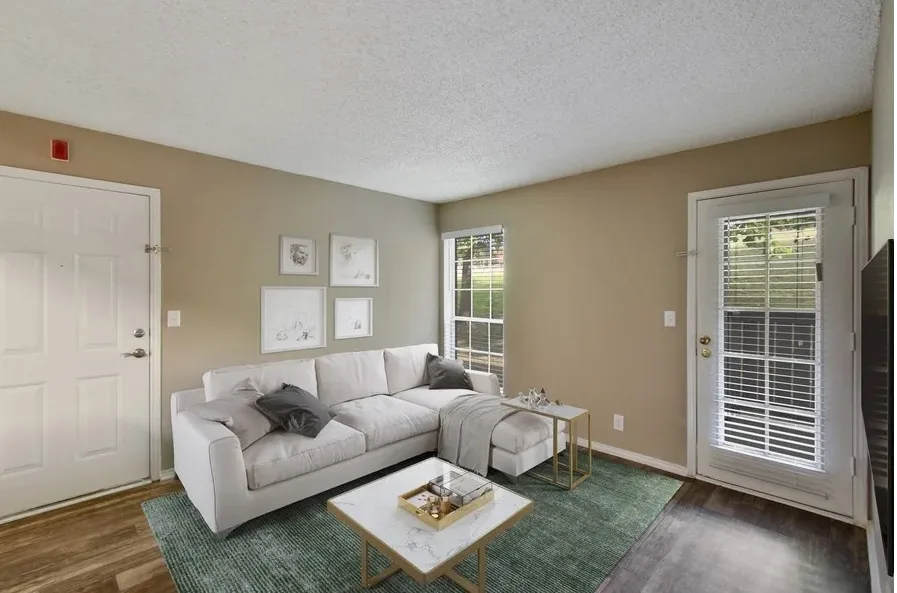 a living room with a couch, coffee table and television at The Hickory Highlands